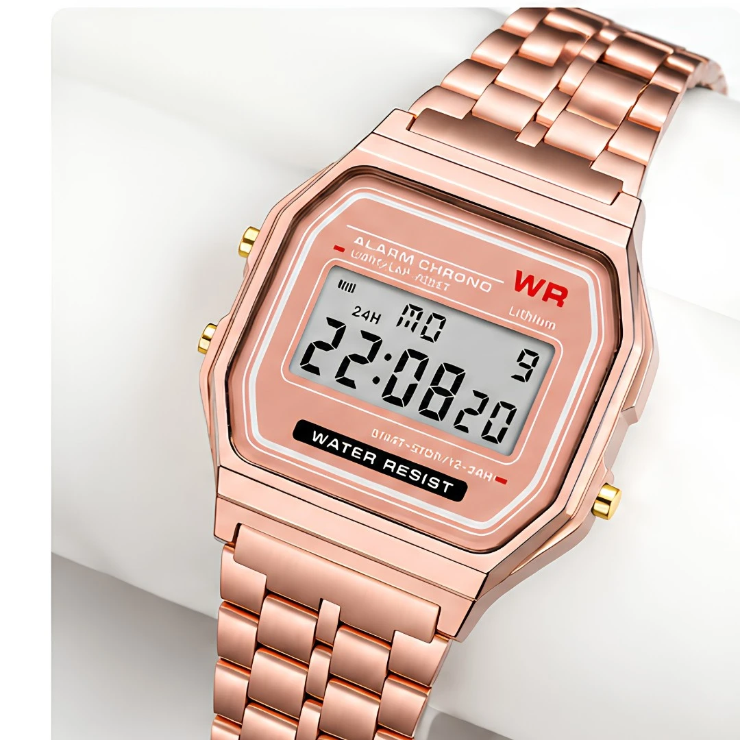 Close angled view of the square digital face and side pushers in a rose gold metal case