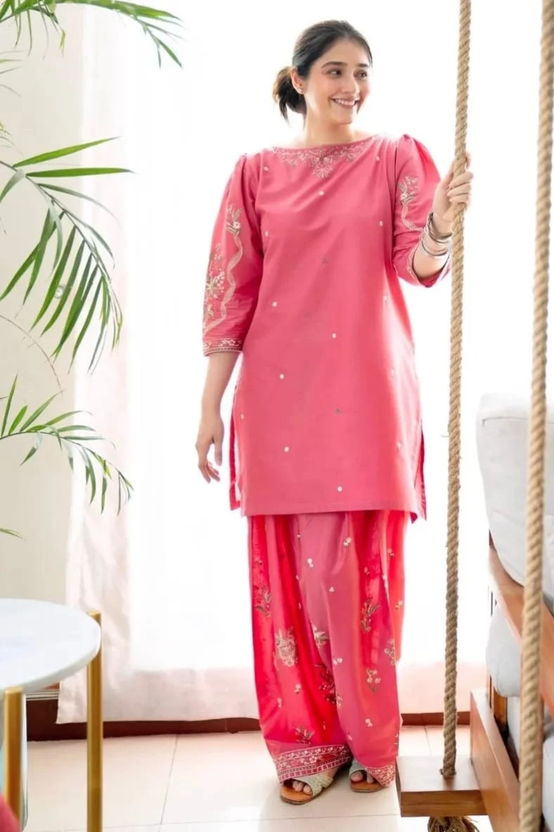 Full-length view of pink heavy embroidery kurta and palazzo-style set
