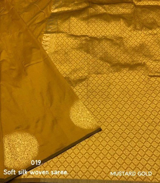 Mustard gold saree flat lay showing soft silk fabric and detailed woven jacquard pallu