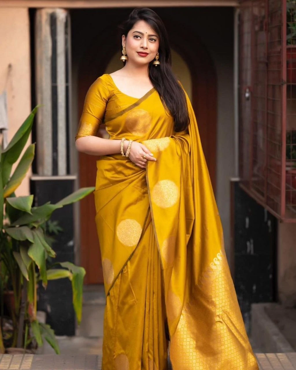 Full-length mustard gold saree with zari motifs and rich jacquard pallu