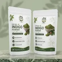 Two standing indigo powder pouches displayed side by side with bowl and scoop graphics on the labels