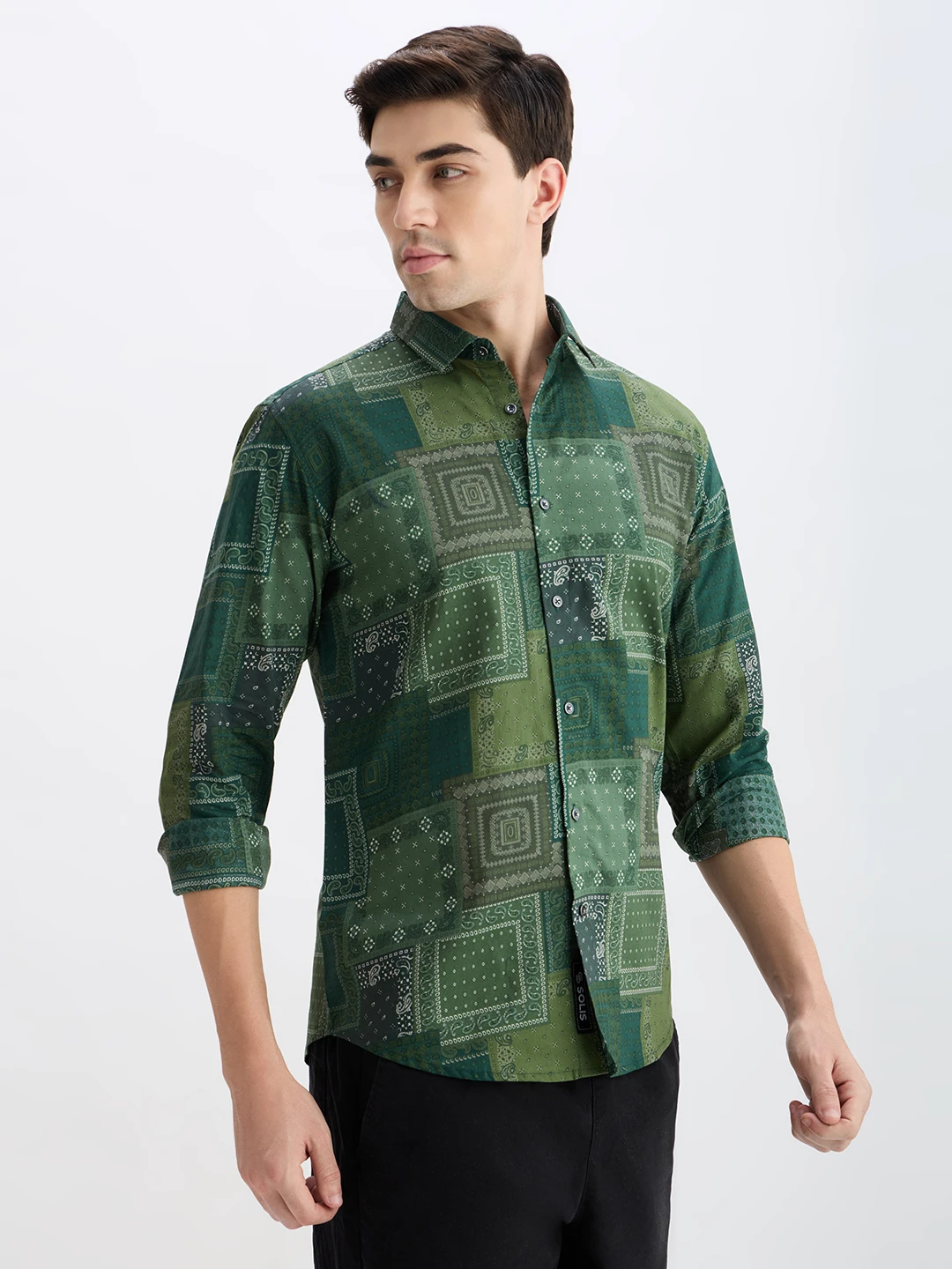 Angled front view of the shirt highlighting the patchwork print and curved hem