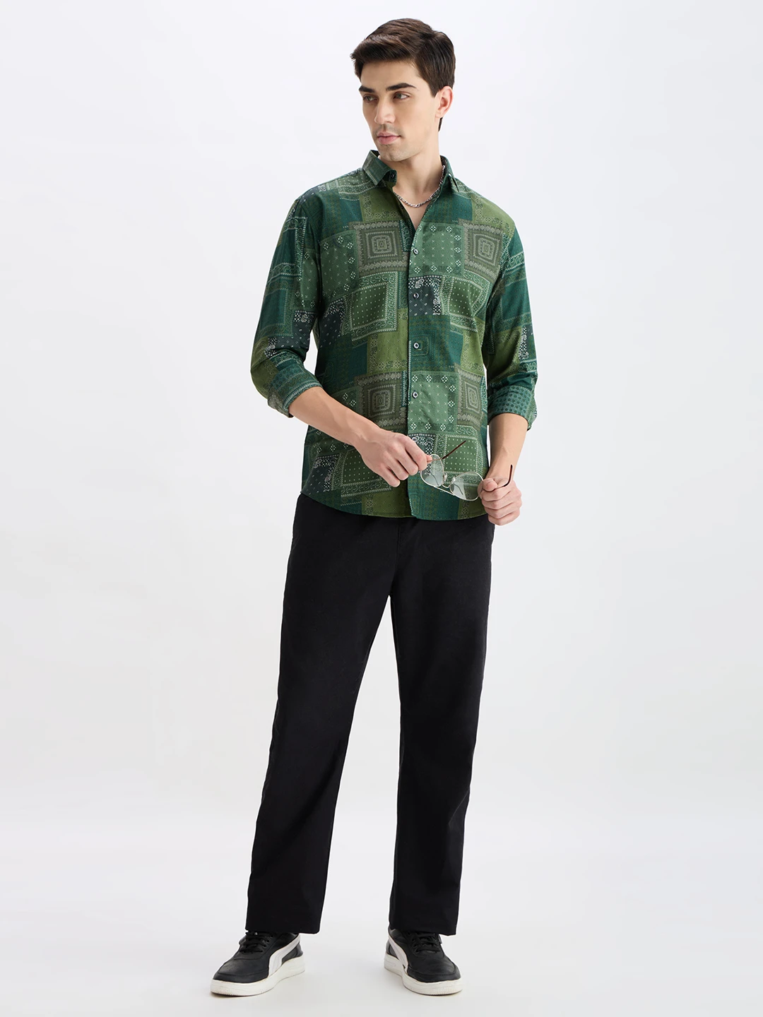 Full-length styled view of the shirt paired with black trousers and sneakers