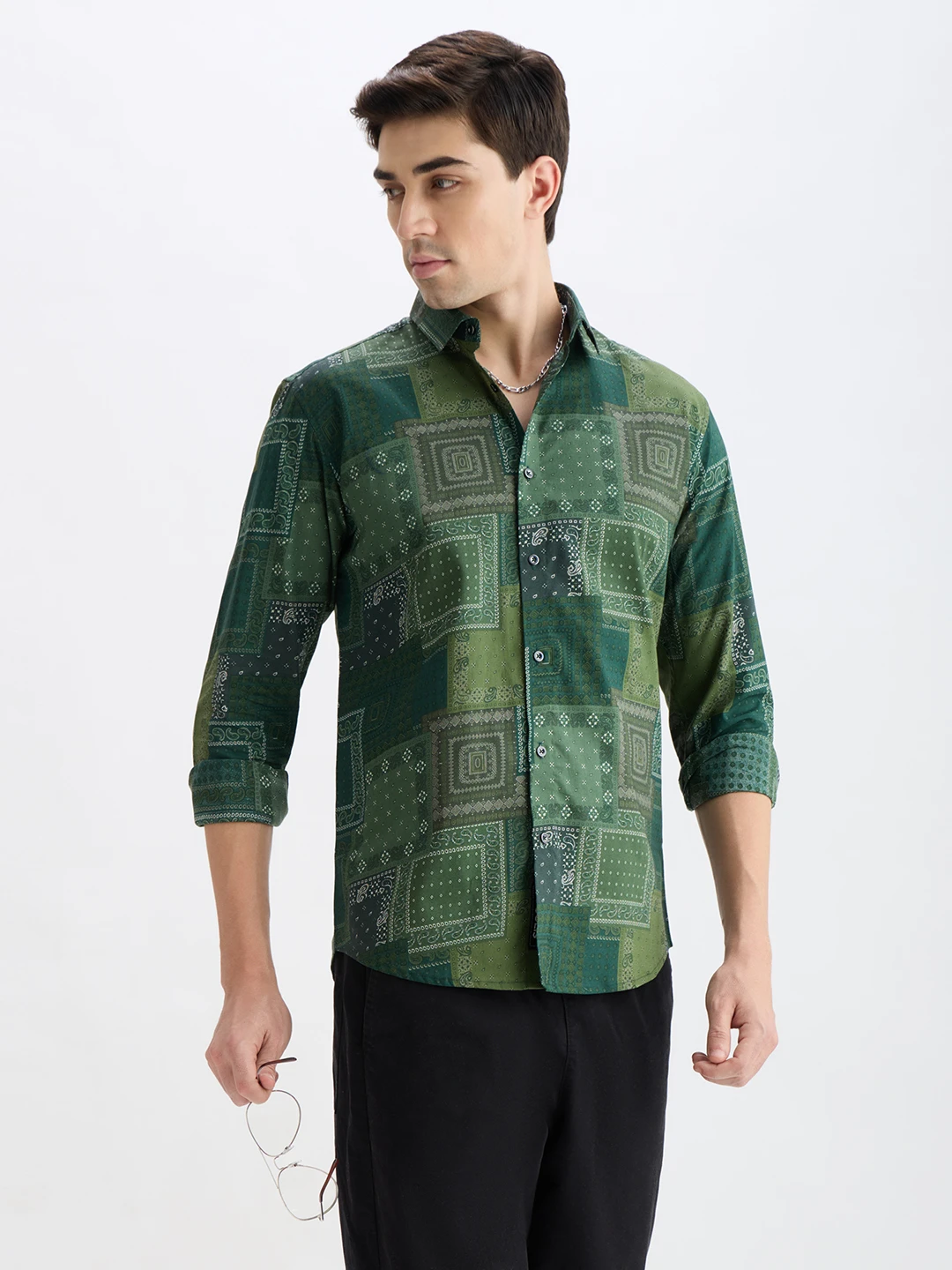 Front angled view of the shirt with rolled sleeves, model holding eyeglasses