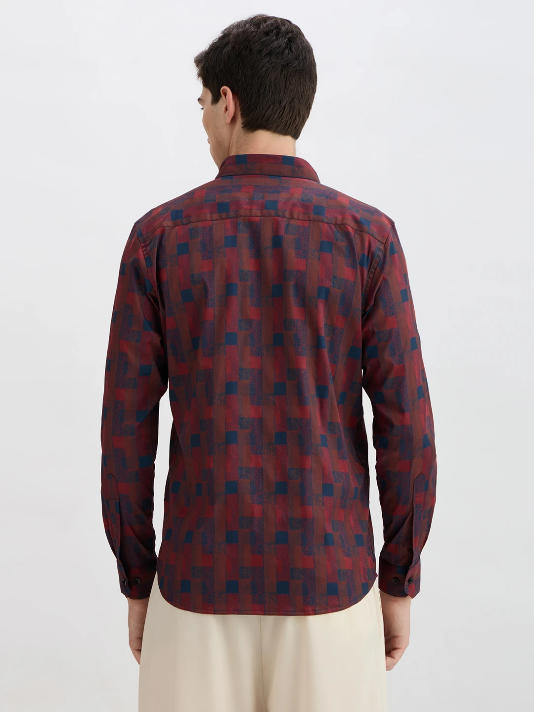 Back view of the shirt showing full print, yoke seam, and long sleeves