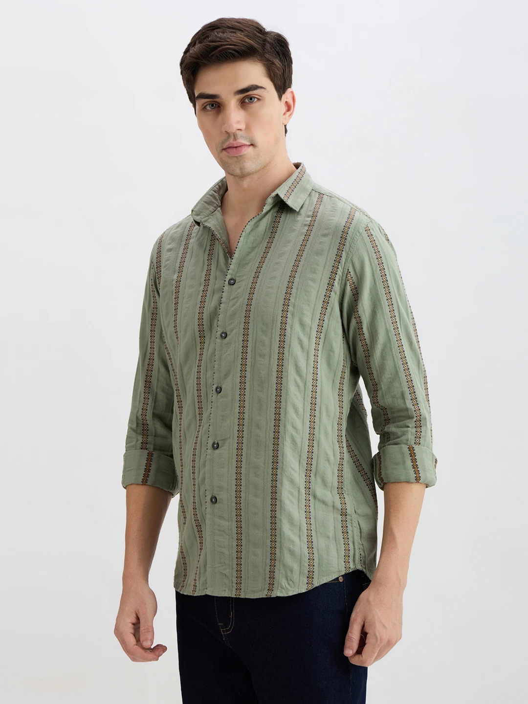 Three-quarter left view showing the shirt's vertical stripe pattern and relaxed fit