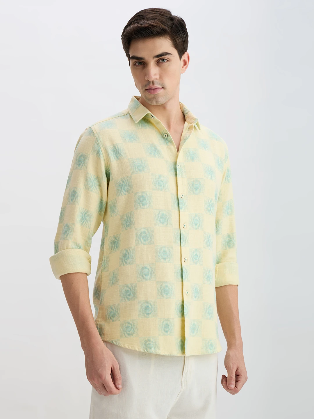 Three-quarter front view highlighting the pastel checks and button placket