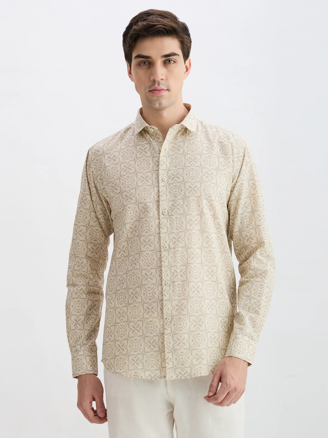 Front view of beige long-sleeve shirt with geometric all-over print and button-down closure
