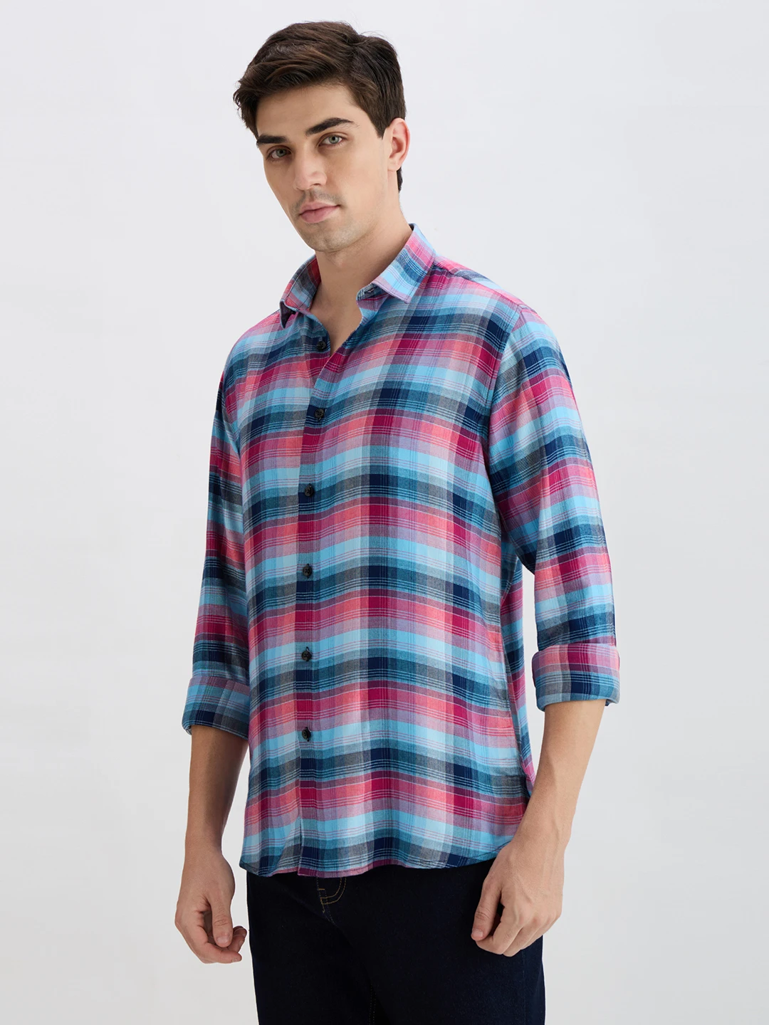 Three-quarter front angle showing the checked pattern and relaxed fit of the collared shirt