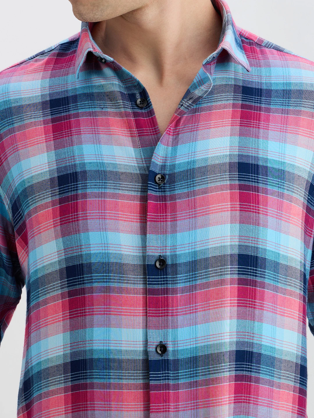 Close-up of the spread collar, black buttons and woven check detail on the shirt front