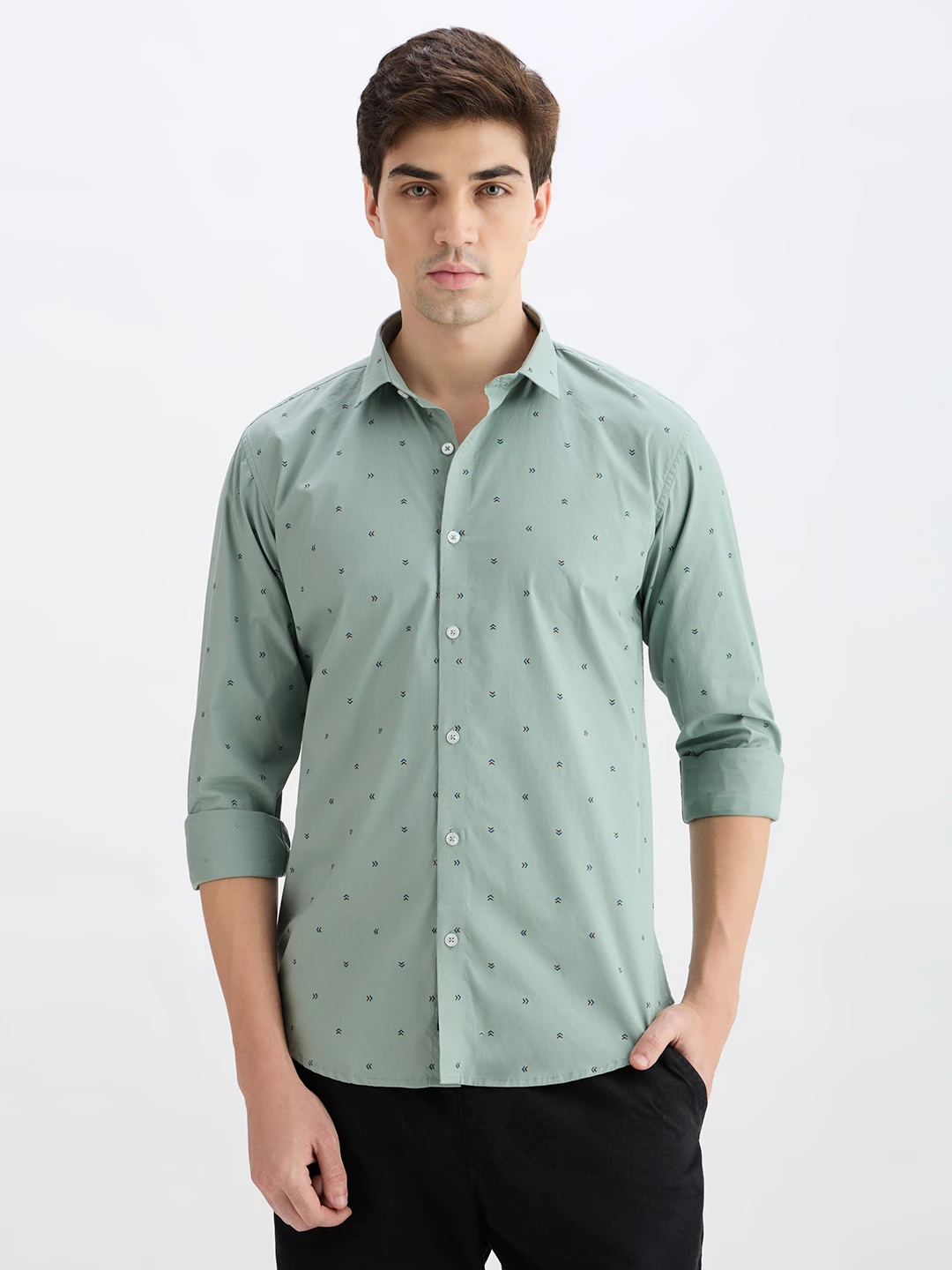 Front view of sage green printed shirt with rolled cuffs and button-down front