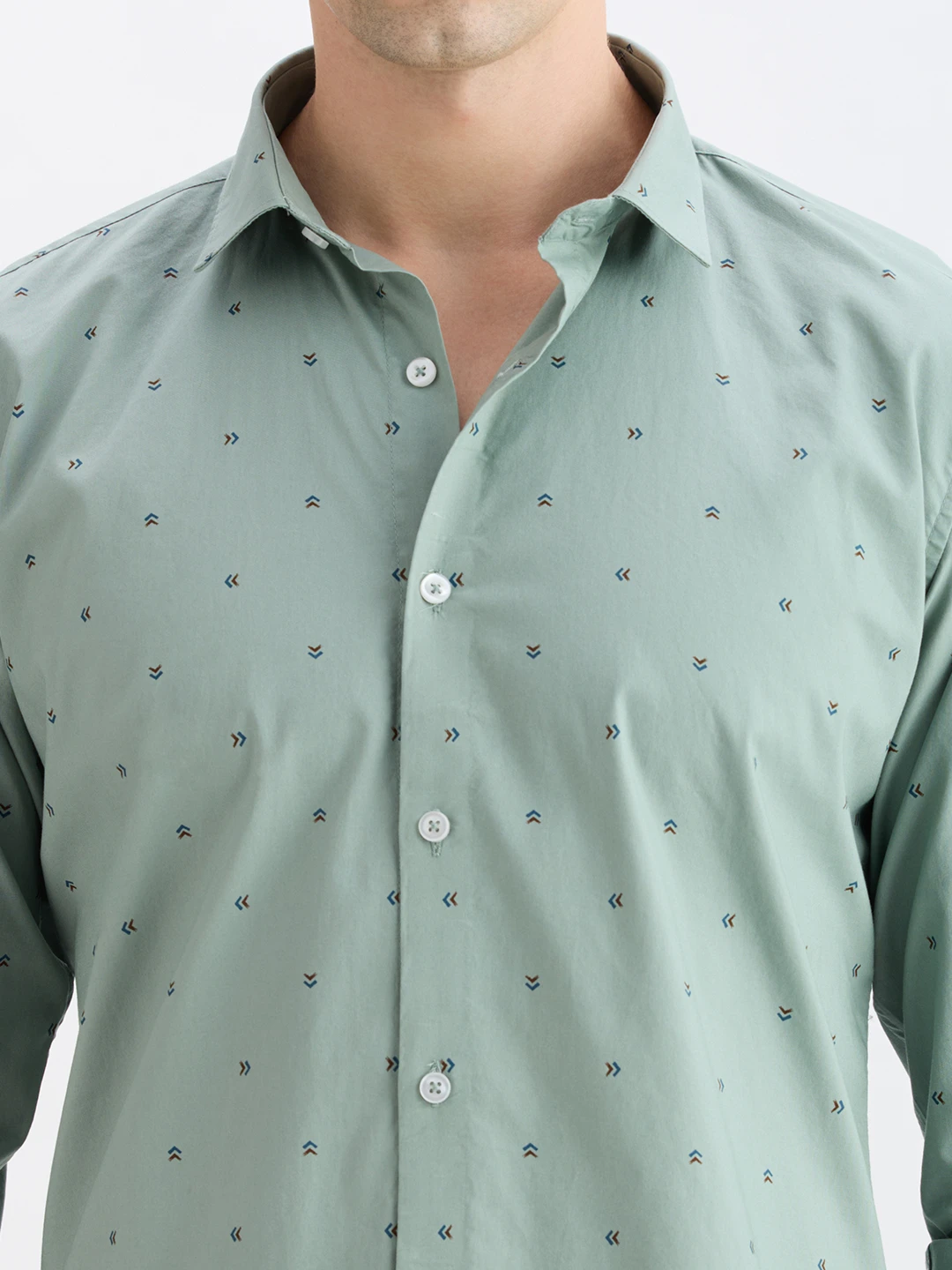 Close-up of collar, placket and white buttons on the printed sage green fabric