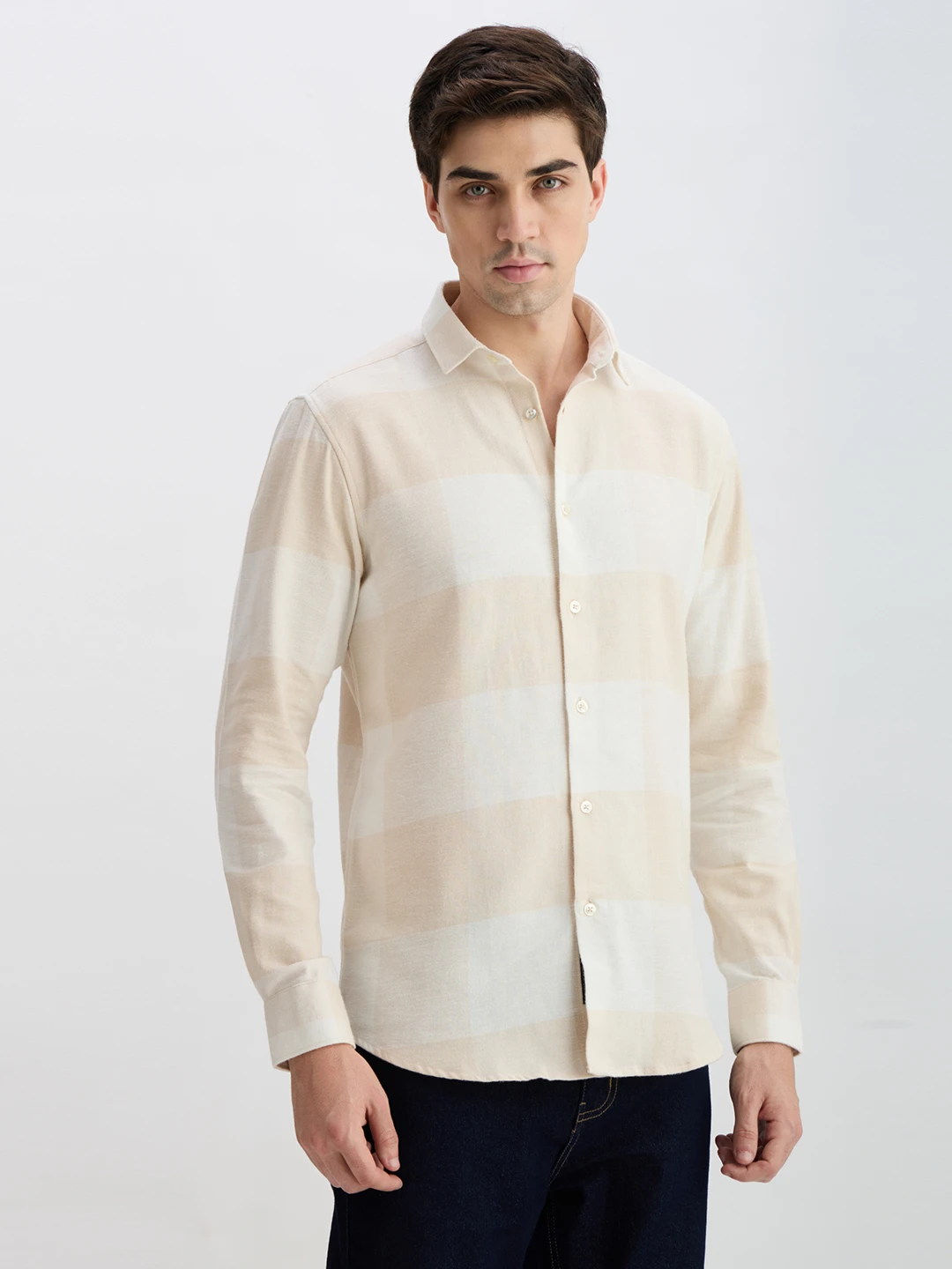 Three-quarter right view of the collared shirt with full sleeves and pale check design