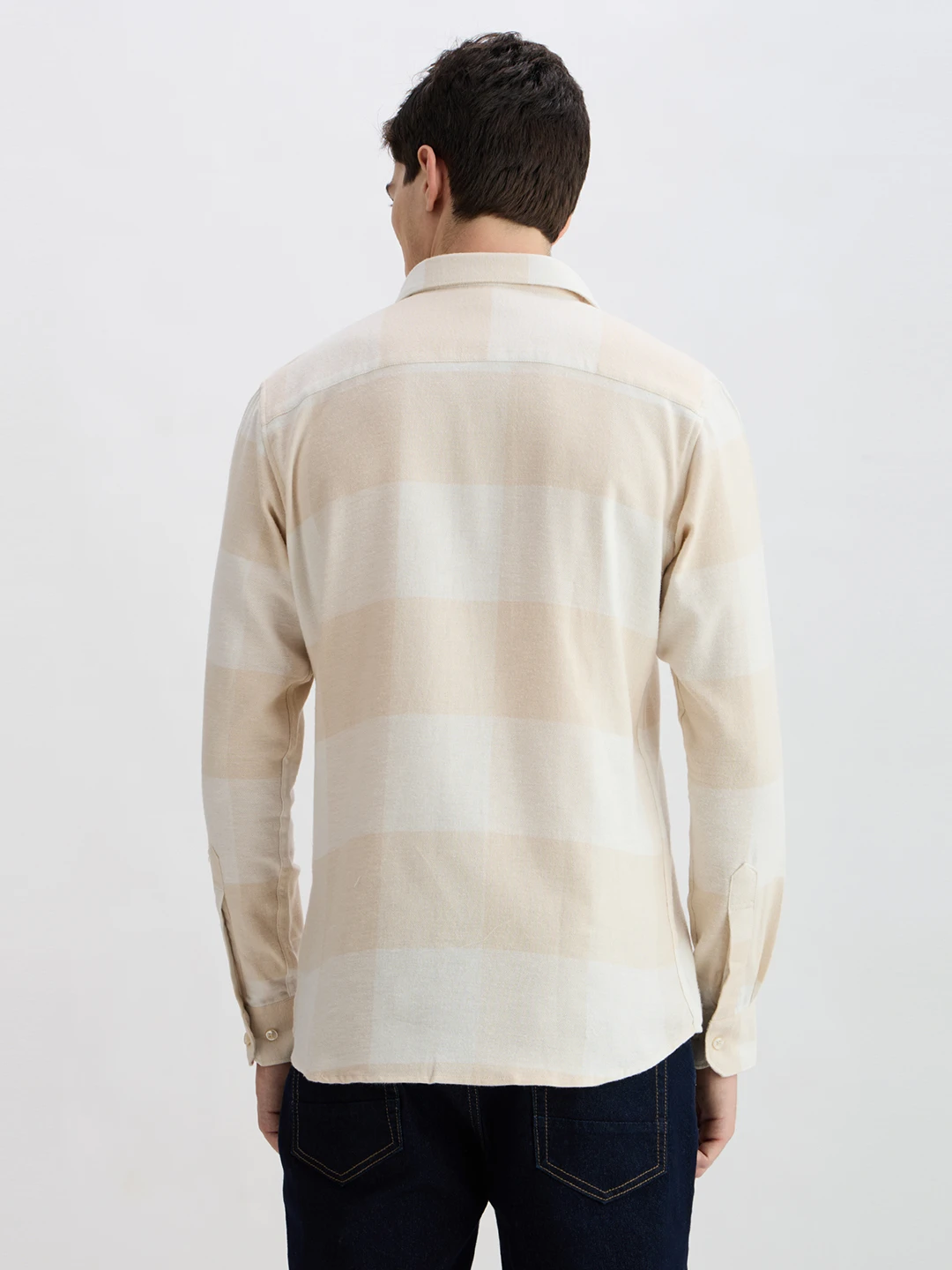 Back view showing the cream oversized check pattern across the full shirt