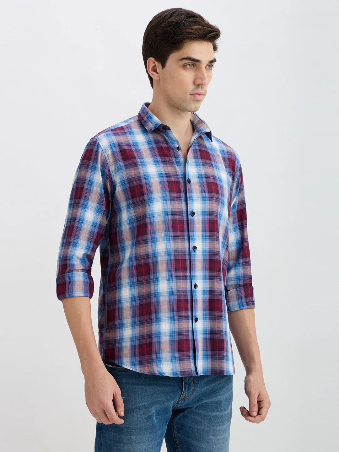 Three-quarter side view highlighting the collar and curved hem of the plaid shirt