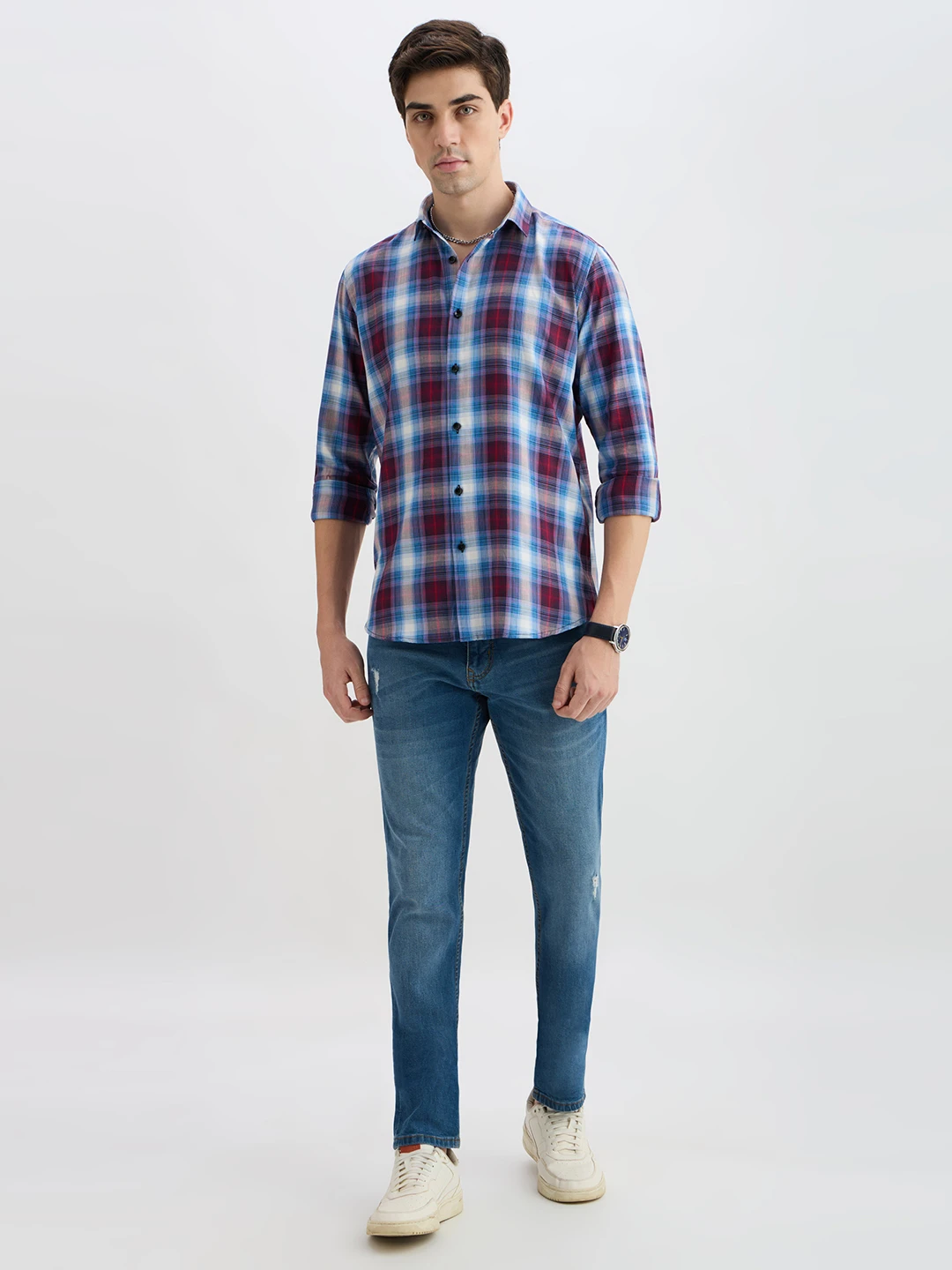 Full-body styling view with the checked shirt paired with blue jeans and white sneakers