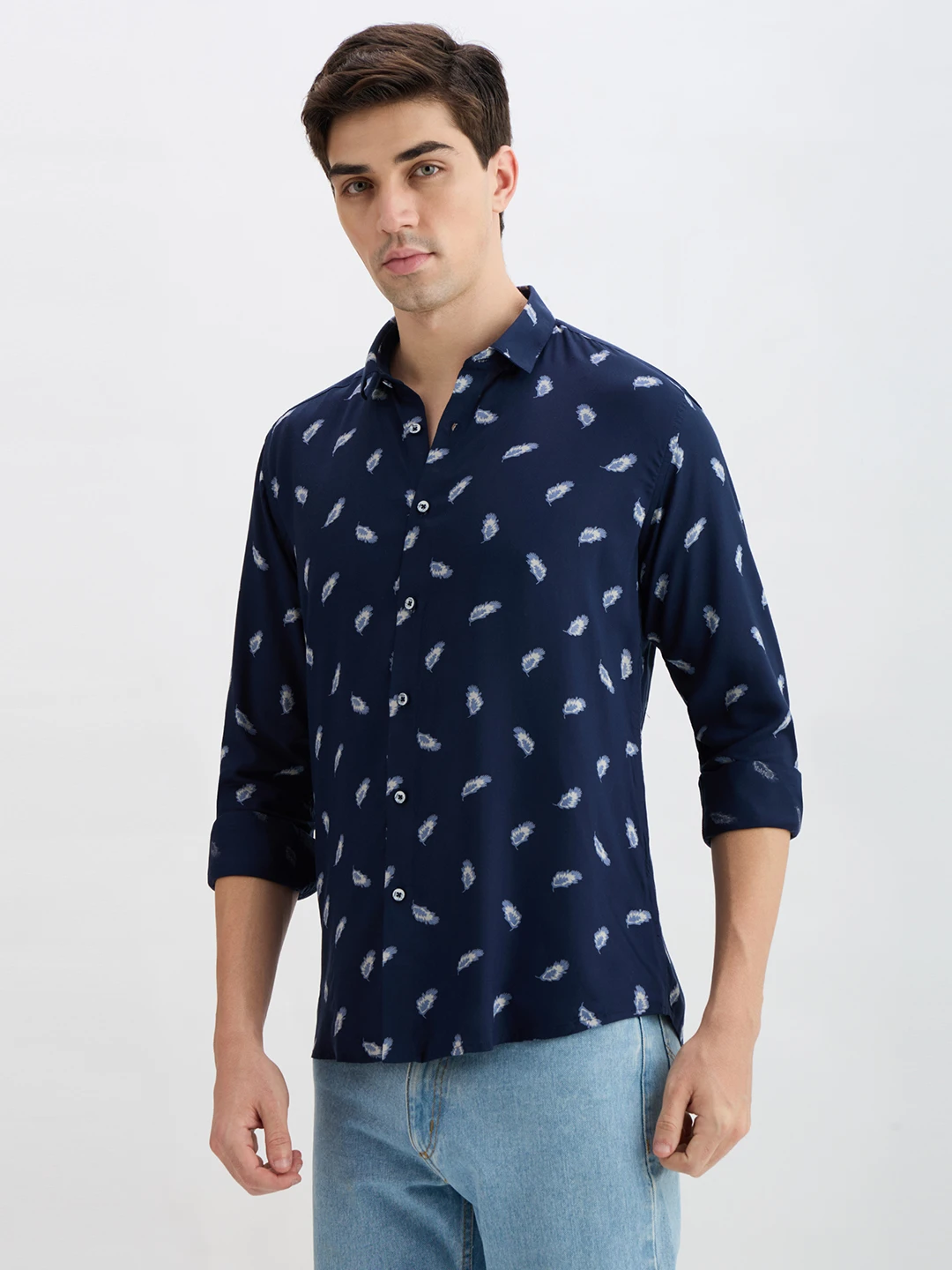 Angled front-left view showing the feather print and button placket on the navy shirt
