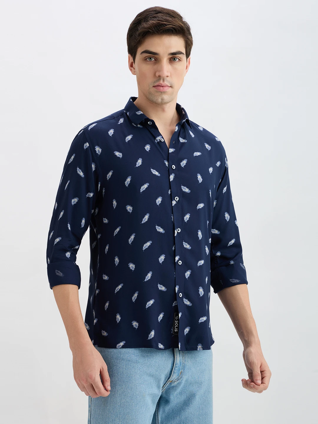 Front-right view of the shirt with rolled cuffs and visible Solis hem tag
