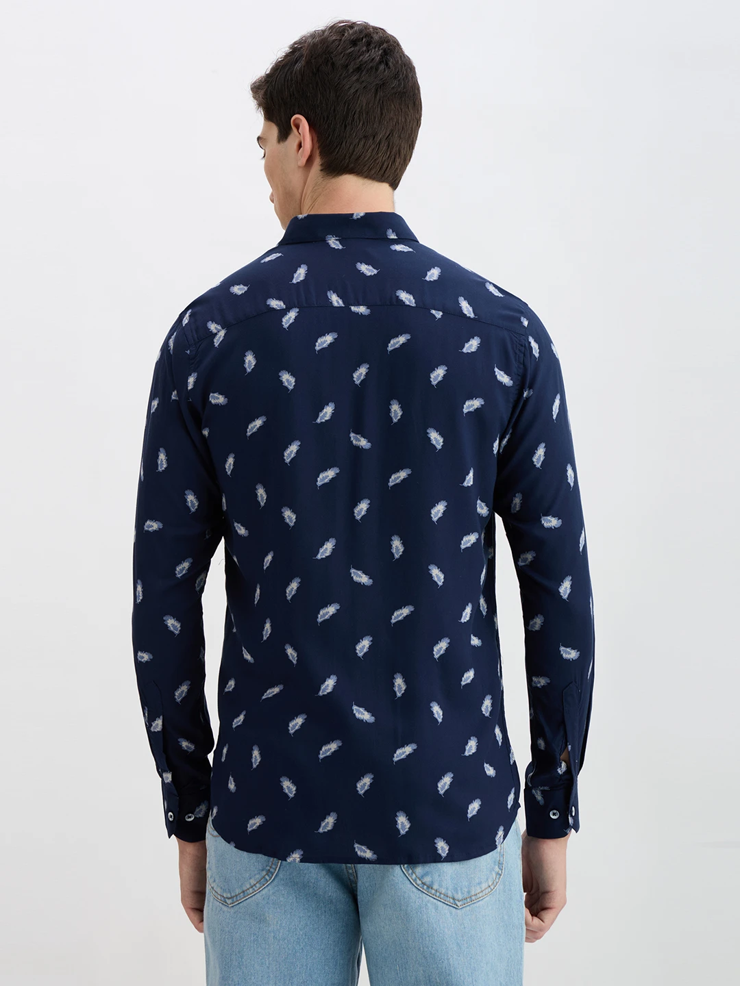 Back view of the navy feather print shirt showing full rear pattern coverage