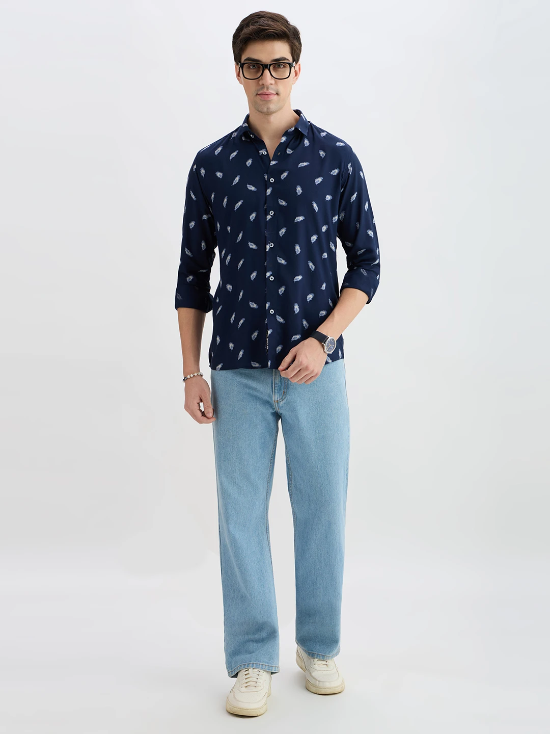 Full-body styling view with the shirt paired with light blue jeans and white sneakers
