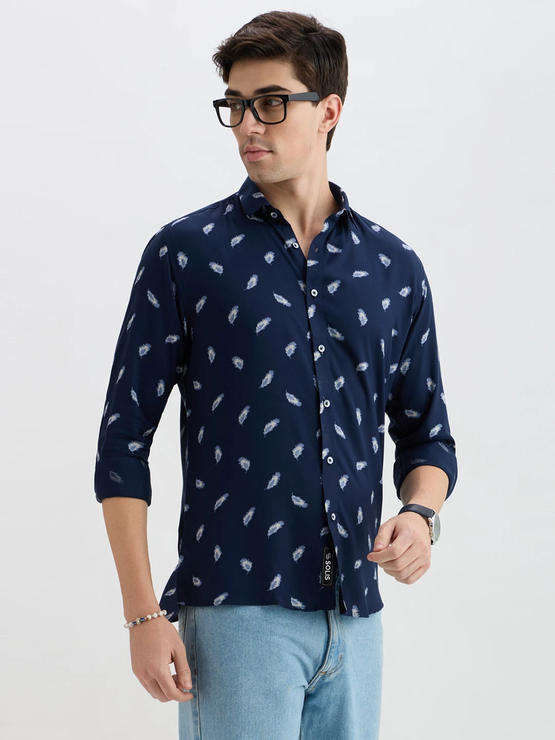 Three-quarter view of the shirt on model with glasses, bracelet and watch