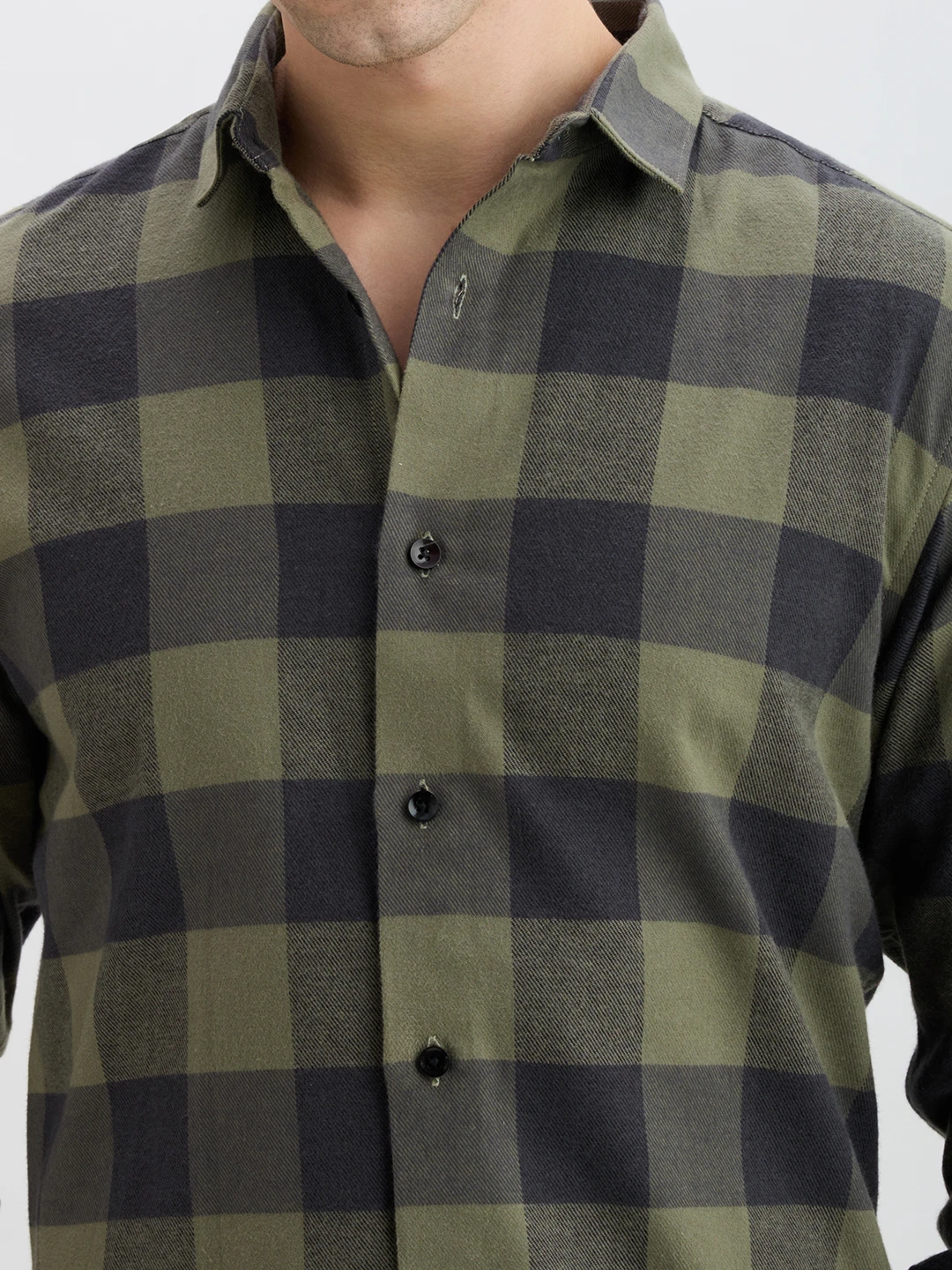 Close-up of collar, button placket and soft brushed check fabric in olive and charcoal tones
