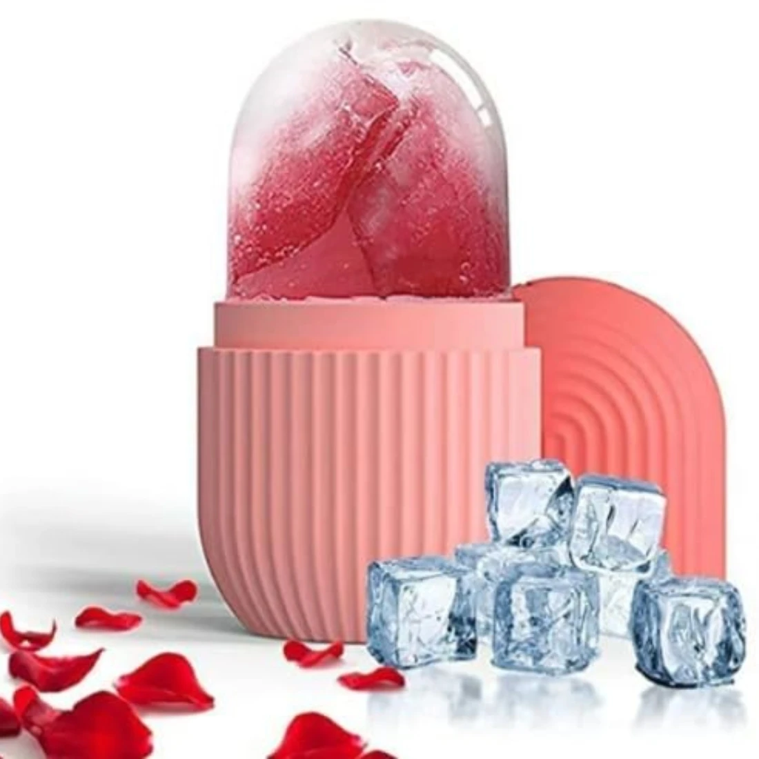 Open pink facial ice roller with red frozen insert, cap behind, and ice cubes with rose petals