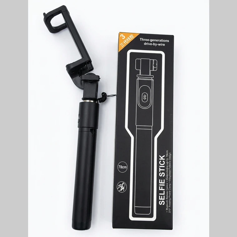 Folded black selfie stick beside retail box showing wired shutter design and 78cm length