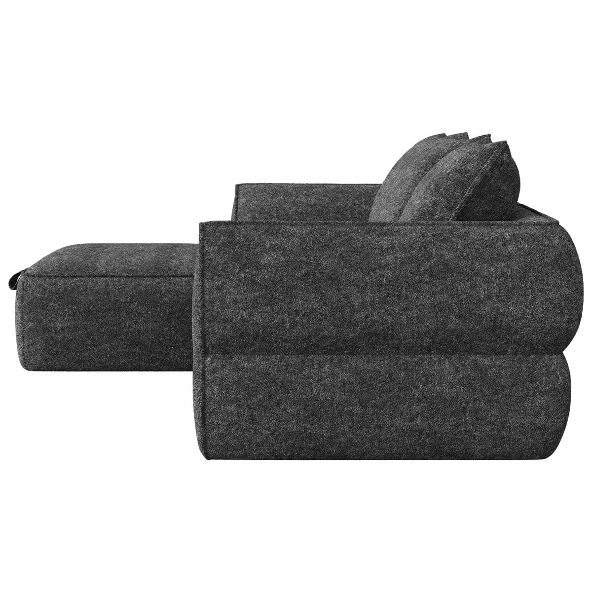 Side profile of the sofa and ottoman showing low arms, deep cushions and textured dark grey fabric