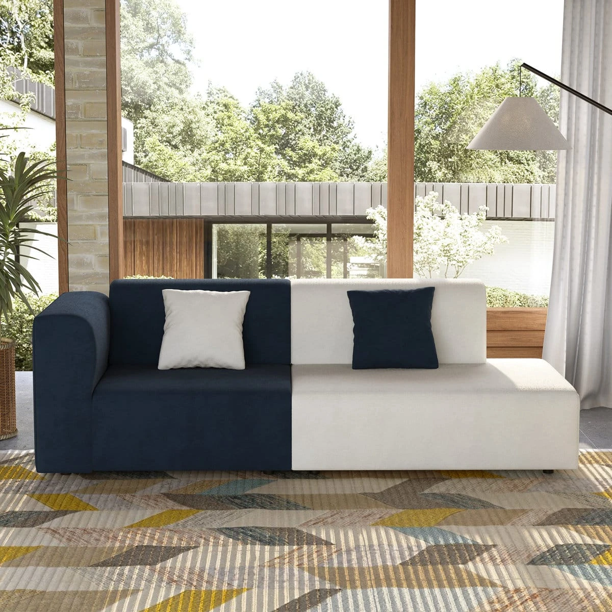 Straight-on front view of the navy and white sofa with two square pillows