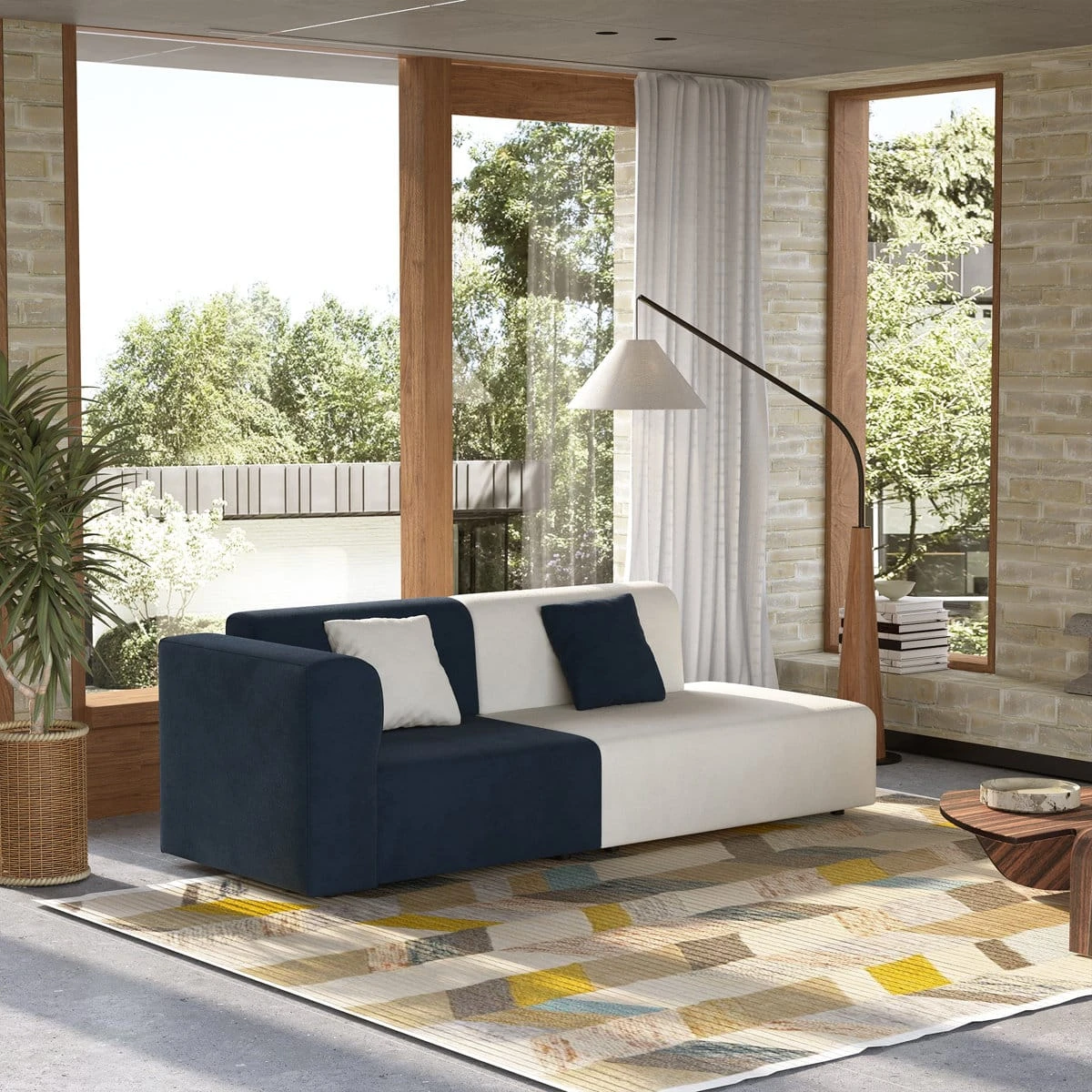 Wide room setting with the two-tone sofa placed on a patterned area rug