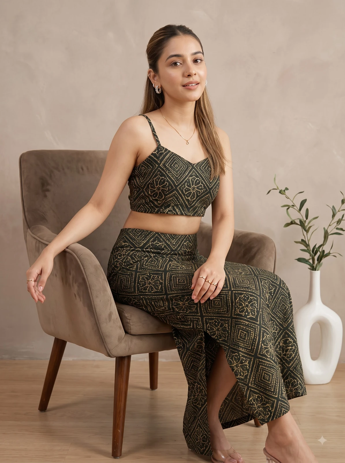 Seated styling view highlighting the fitted bodice and geometric floral print on the maxi skirt