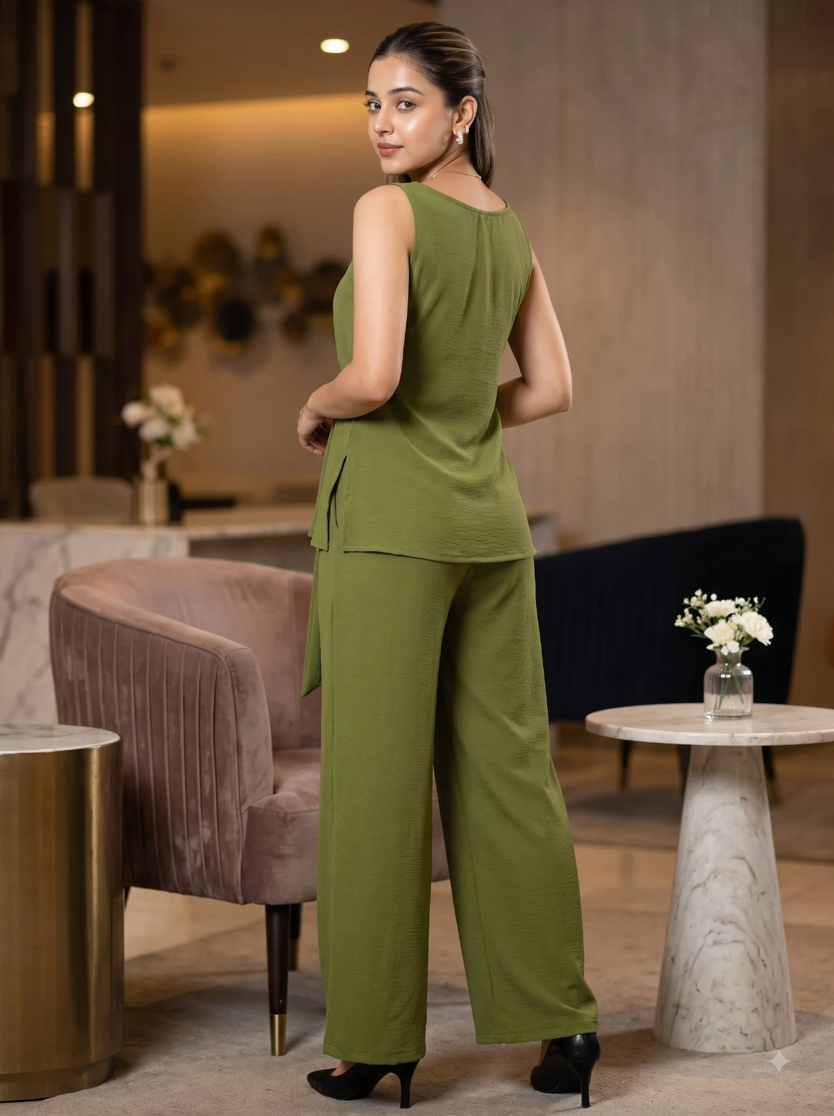 Rear three-quarter view of olive set showing side slit top hem and loose straight pants