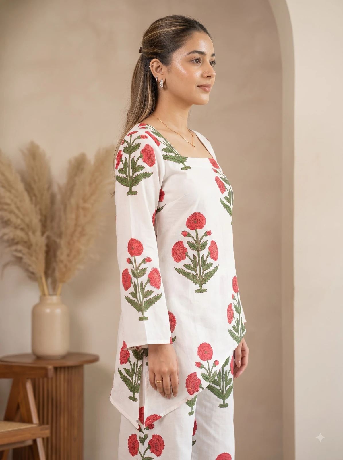 Side profile showing the square-neck kurta, long sleeves, and red floral print placement