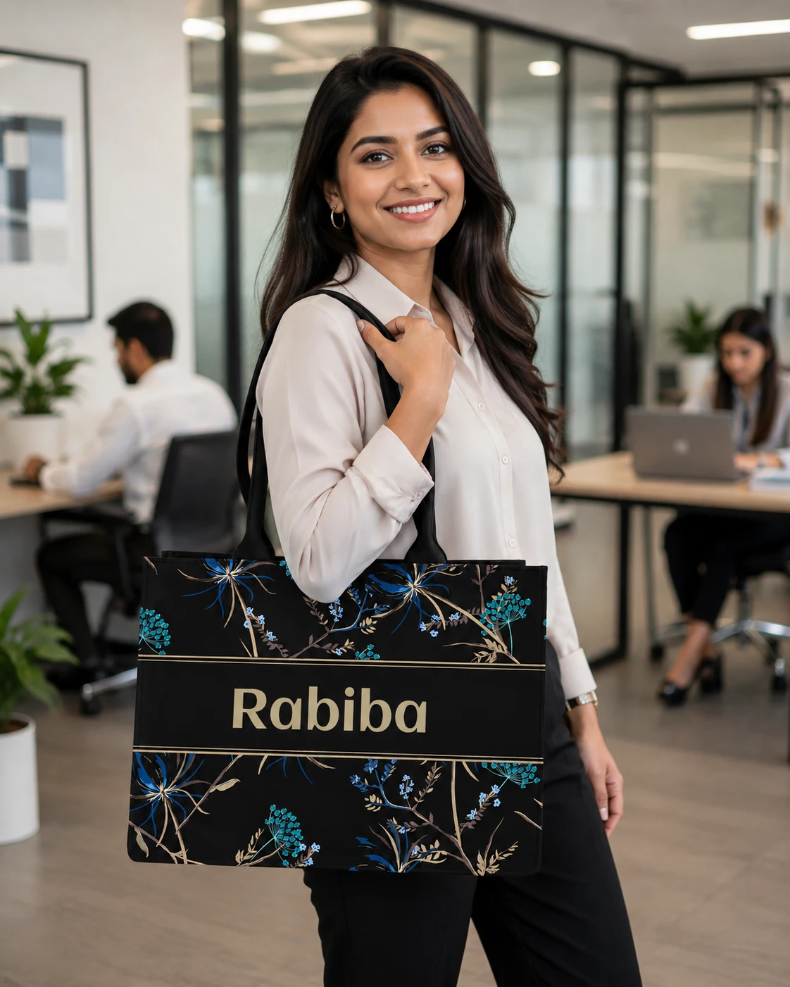 Personalized floral tote worn on shoulder in office, showing Rabiba name on front band