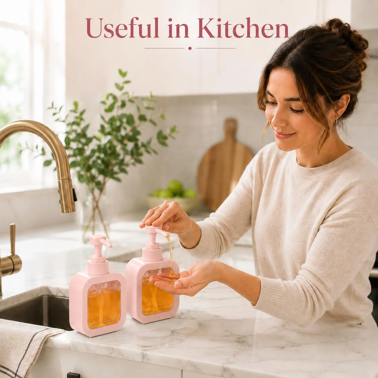 Pink soap dispenser bottles used beside a kitchen sink, with one pump dispensing amber liquid into a hand