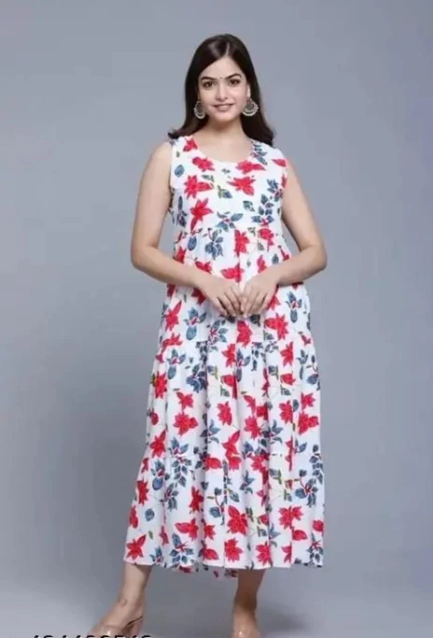 Front view of white sleeveless maxi dress with red and blue floral print and flared hem