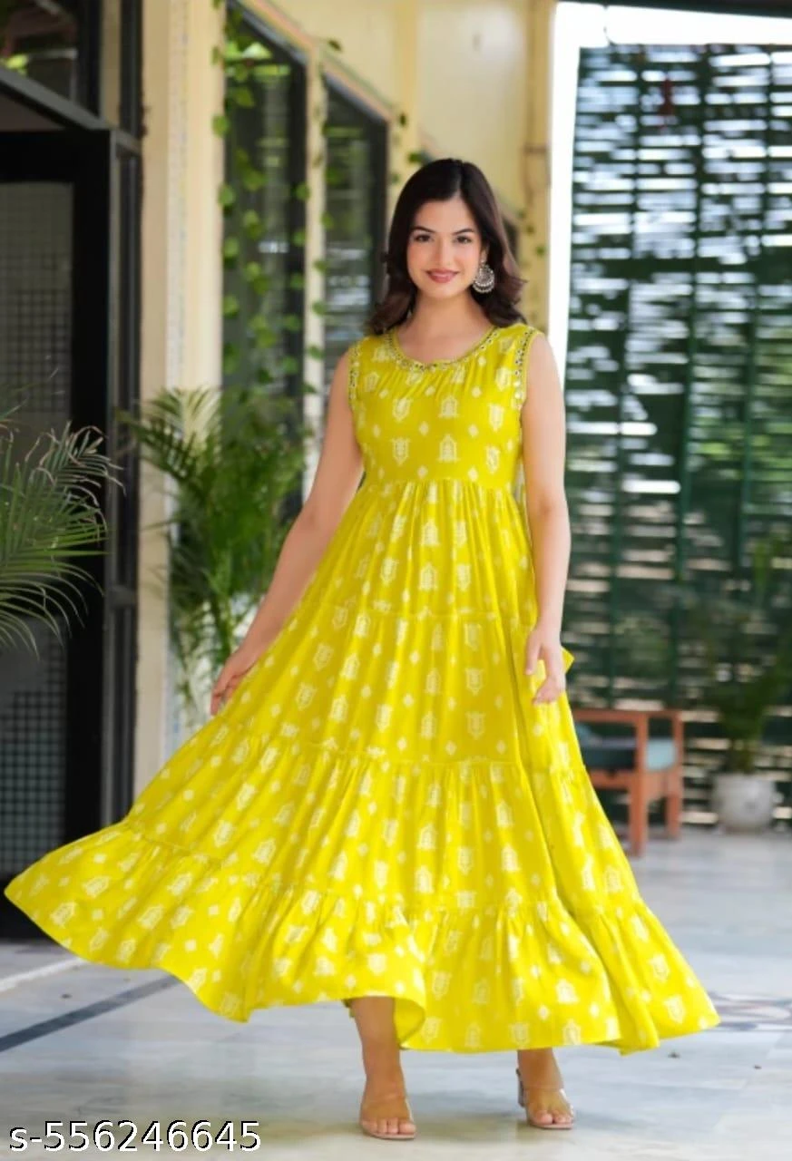 Sleeveless yellow printed maxi dress with tiered flared hem shown in a full-length outdoor front view