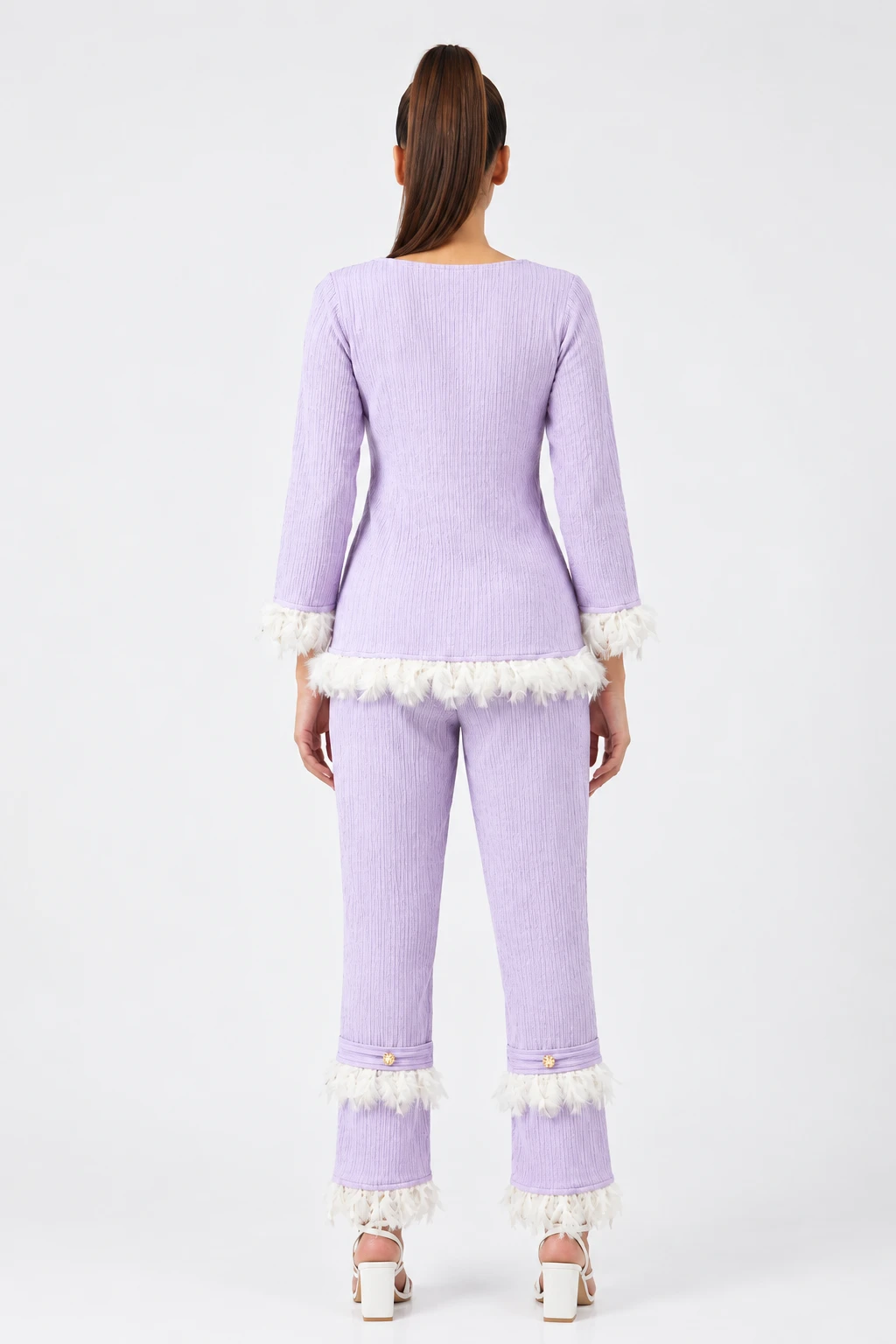 Back view of the lilac co-ord set highlighting the fitted top and feather accents at hem and ankles