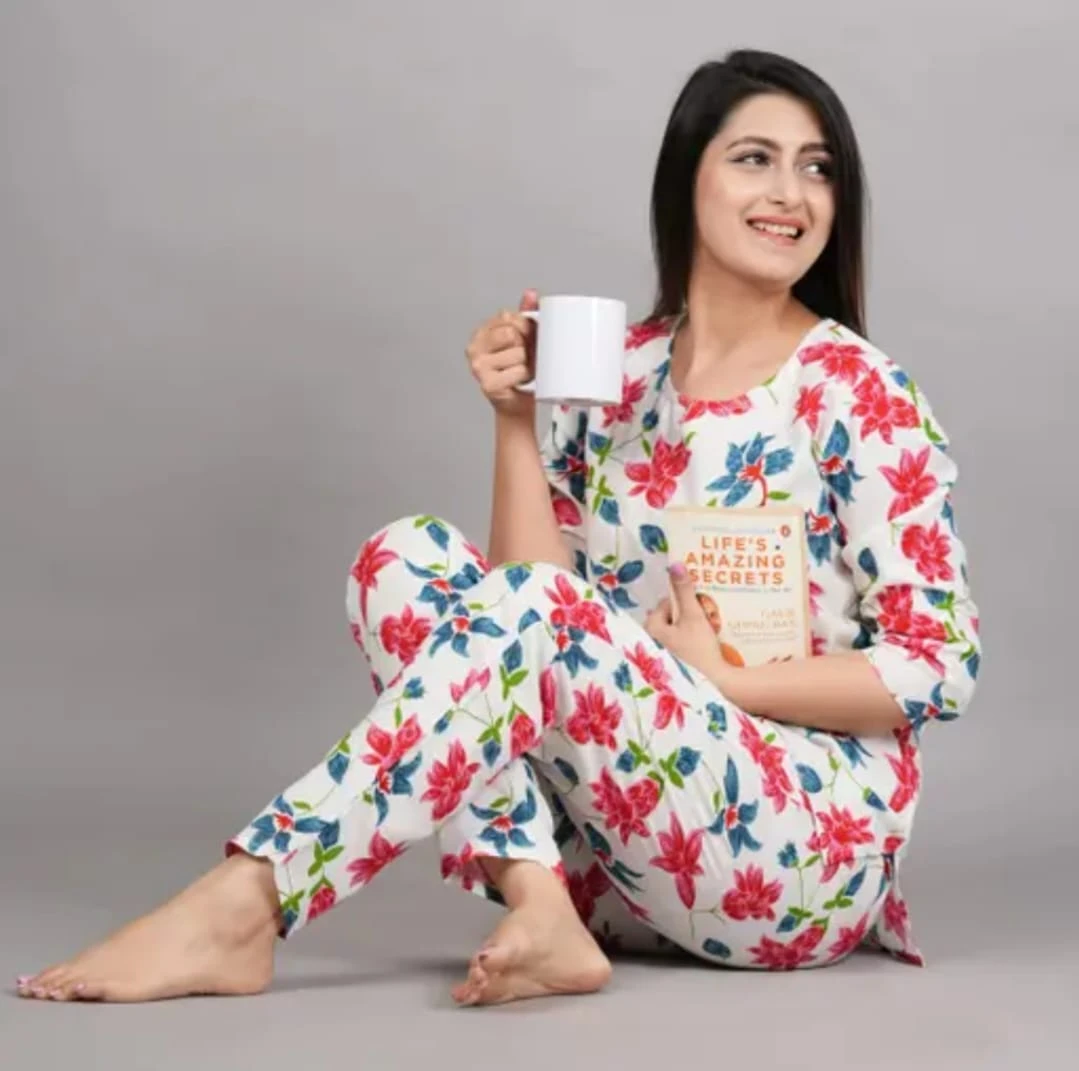 Front view of women's white lounge co-ord set with pink floral print and matching tapered pants