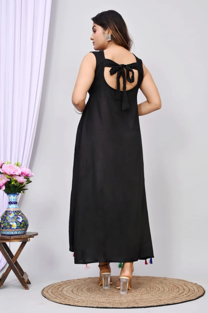 Back view showing tie-up open back on black maxi dress with tassel accents at the hem