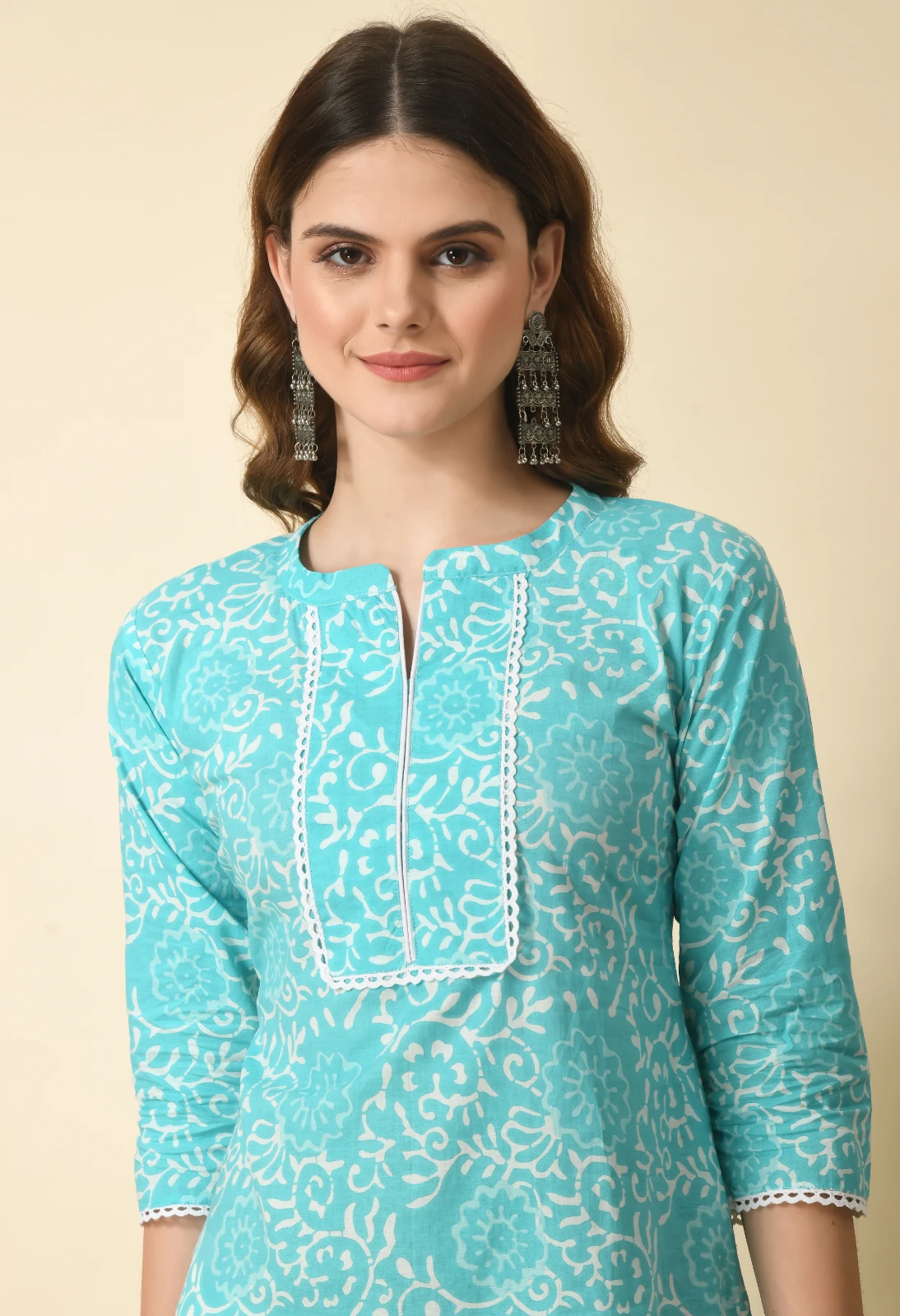 Upper-body view highlighting the split round neckline and white lace-trim bib panel on the turquoise kurta
