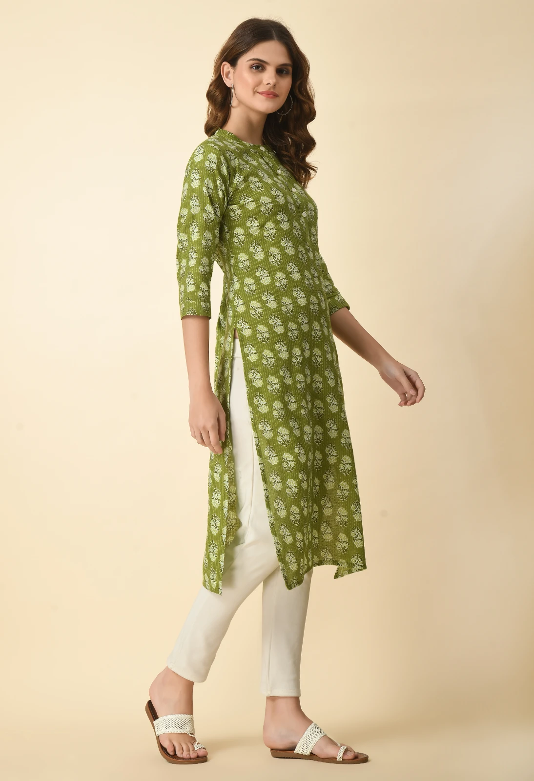 Three-quarter side view highlighting the round neck with button placket and high side slit