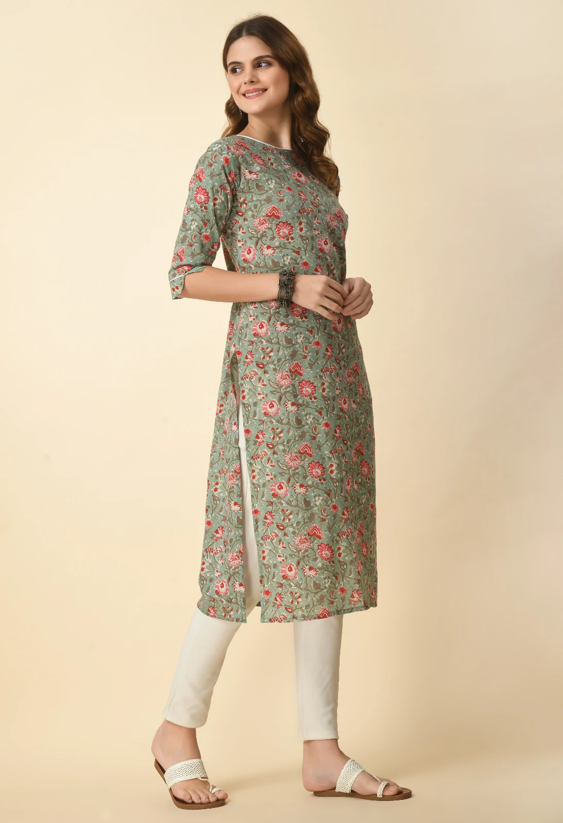 Three-quarter left view highlighting the allover pink floral print and calf-length straight silhouette