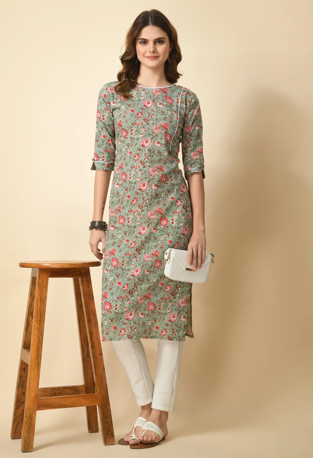 Full-length styled look with sage floral kurta, white clutch, ivory trousers and woven flat sandals