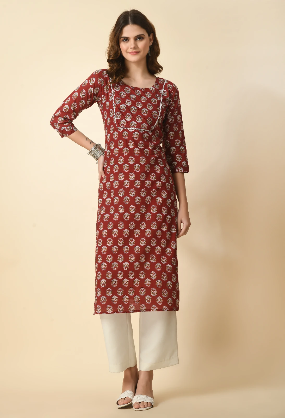 Front view of rust printed straight kurta with round neck, contrast piping and three-quarter sleeves