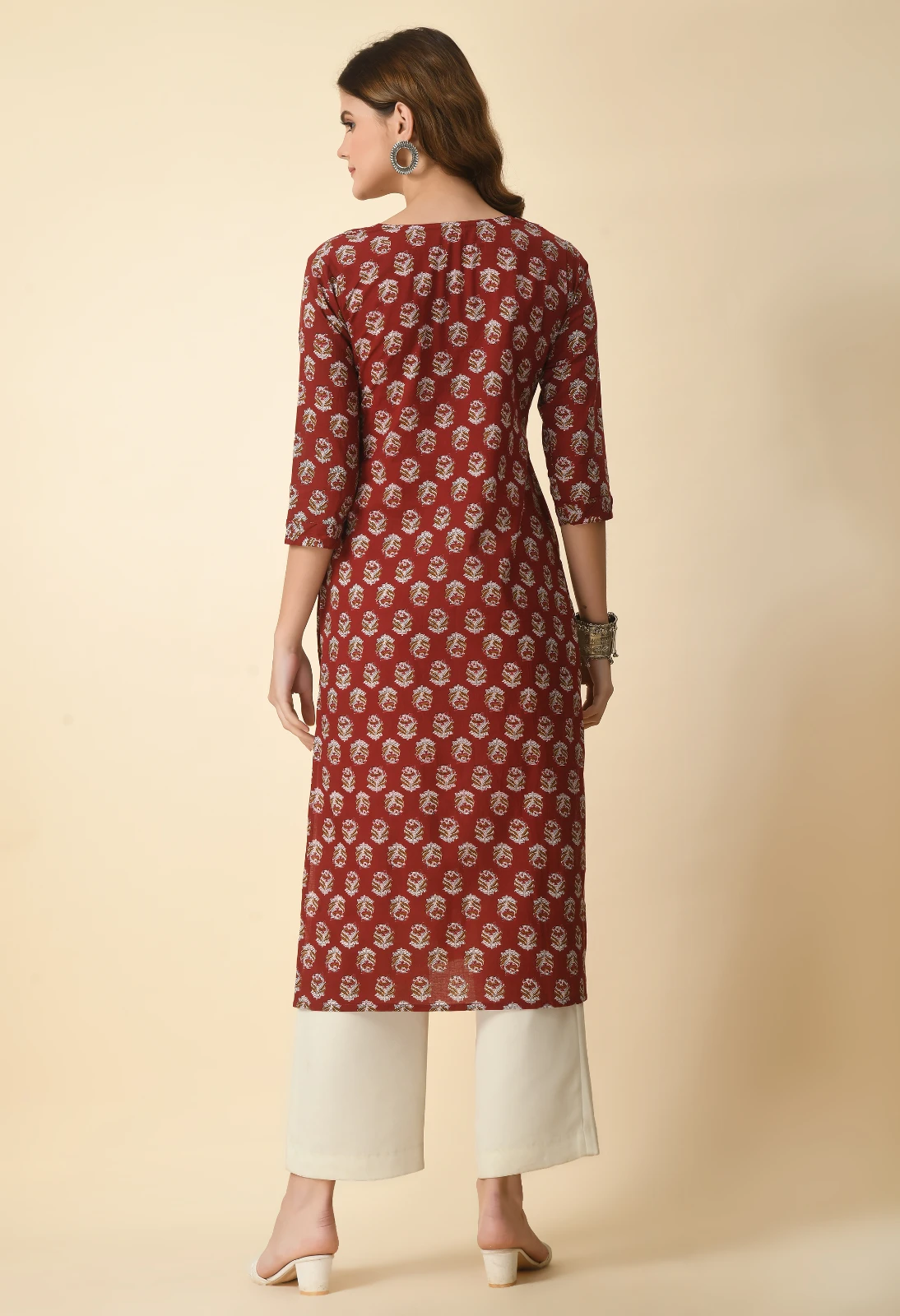 Back view of rust printed straight kurta with three-quarter sleeves and ivory palazzo-style trousers