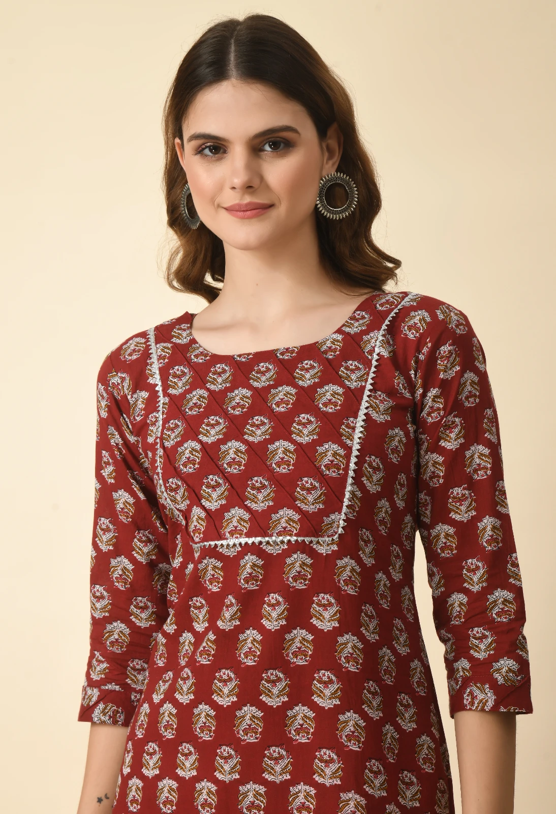 Upper-body view of rust floral block-print kurta with square neckline and silver lace-trimmed bib panel