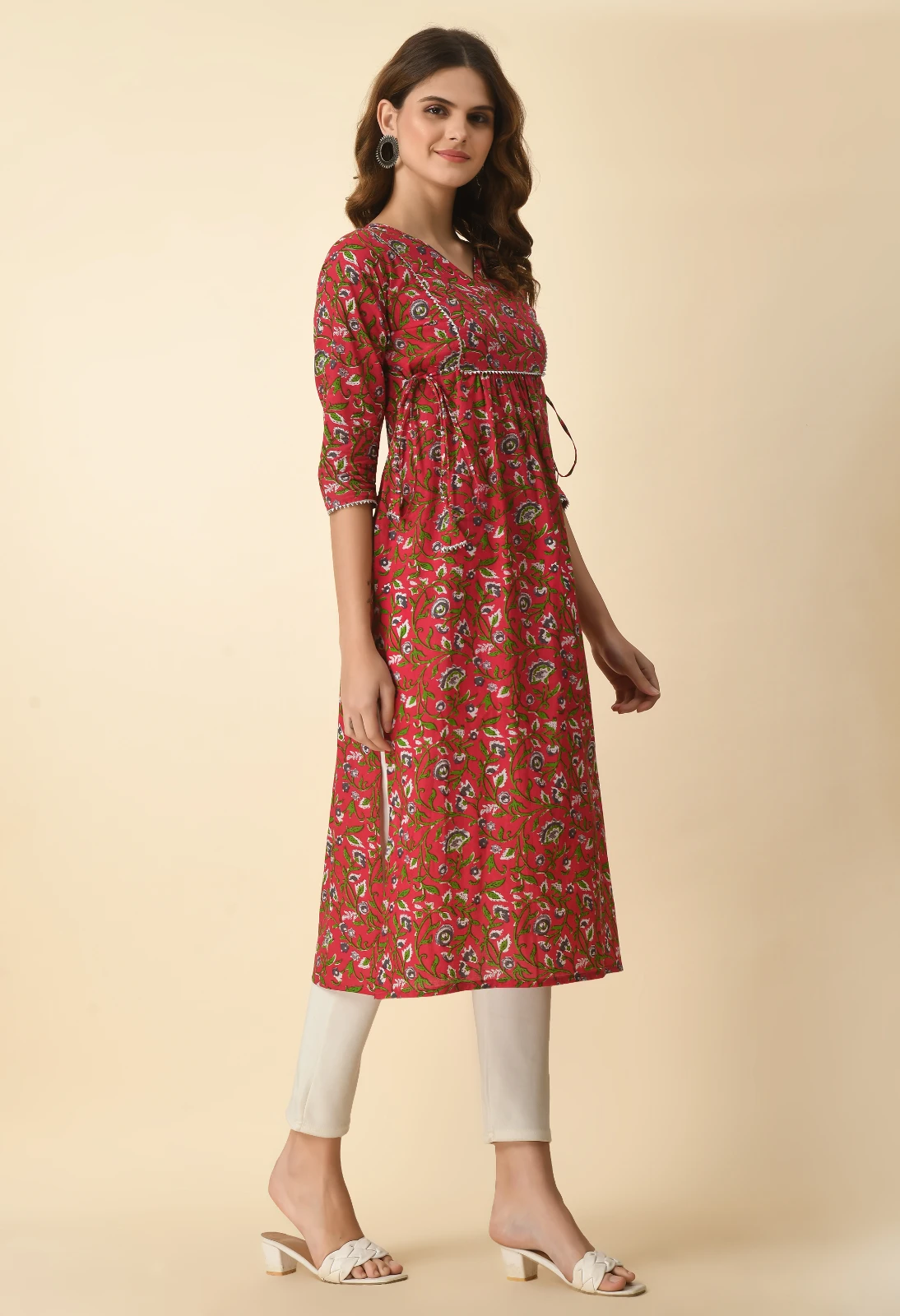 Three-quarter angled view highlighting the side tie strings and calf-length straight hem