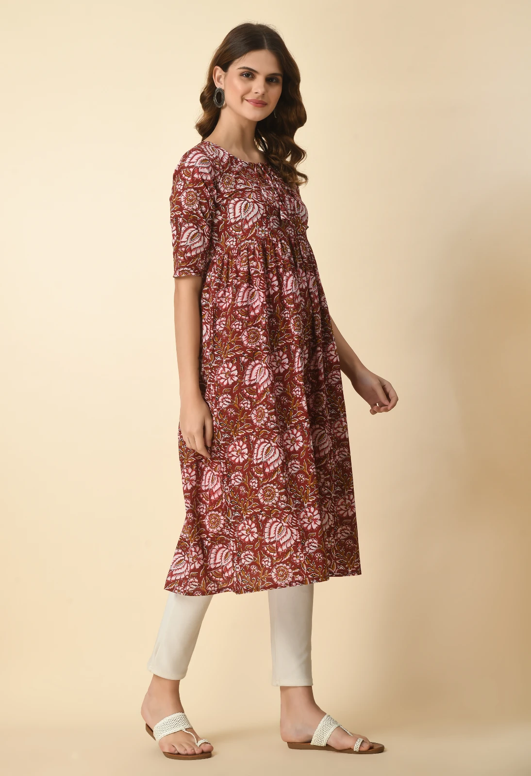 Angled front view highlighting the round tie-up neckline and all-over pink floral print